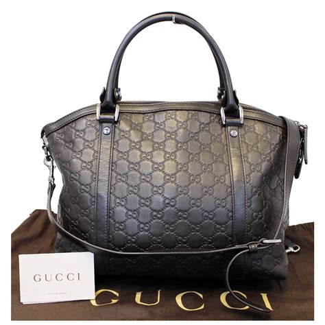 brown gucci handbag next to a black handbag|gucci shoulder bag brown.